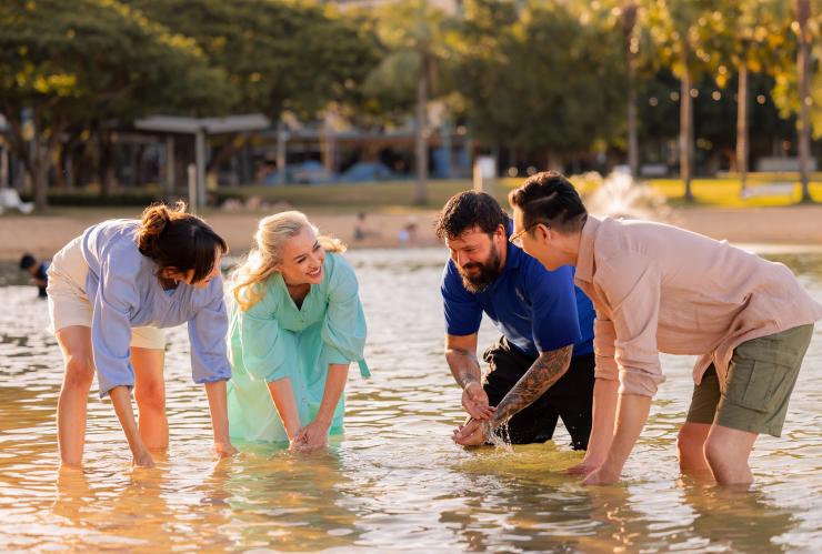 四人站在水中参与一场文化仪式 © Jason Ierace 版权所有